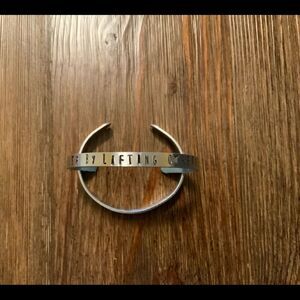 Hand Stamped Rise by‎ lifting others silver cuff